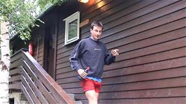 Tao leaves our "cabin" at Flåm Camping / Flåm Youth Hostel, for our late evening walk to the fjord, 49.7 miles from Haugastøl